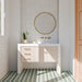Bathroom featuring Cotswolds Rustic White Blanca 7.5cm x 15cm rustic gloss wall tiles, showcasing soft white tones and subtle surface variation, paired with green geometric floor tiles, a fluted vanity and brass details.