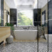 Bathroom interior featuring Decaprio Black & White marble effect patterned porcelain tiles 44 × 44cm, used across the floor and bath panel to create a bold, continuous geometric layout. The structured black and white pattern adds rhythm and contrast, paired with black marble effect wall tiles, wood-effect cabinetry, and matte black fittings for a refined, contemporary finish.