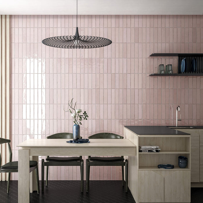 Madison Rose Brick Wall Tiles 6x24.6cm — dining setting displaying the soft blush tones and reflective handcrafted surface. The vertical layout creates a sleek, contemporary feel, while the delicate colour adds warmth and sophistication to modern dining spaces.