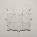 Close-up of Dohar Avorio Rocks Star & Cross porcelain wall and floor tiles, arranged in an interlocking geometric pattern with soft ivory tones, subtle speckled detail and a textured matt finish.