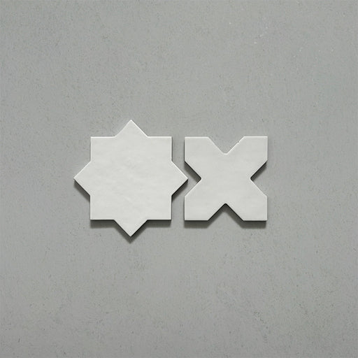 Close-up of Dohar Bone Star and Cross Moroccan style porcelain wall and floor tiles, showcasing complementary geometric shapes, soft off-white tones and a subtle matt finish.
