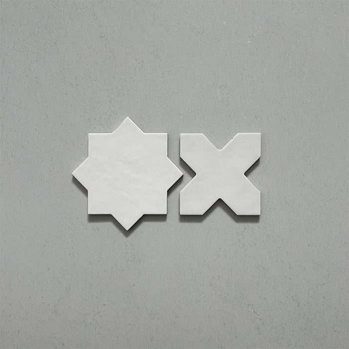 Close-up of Dohar Bone Star and Cross Moroccan style porcelain wall and floor tiles, showcasing complementary geometric shapes, soft off-white tones and a subtle matt finish.