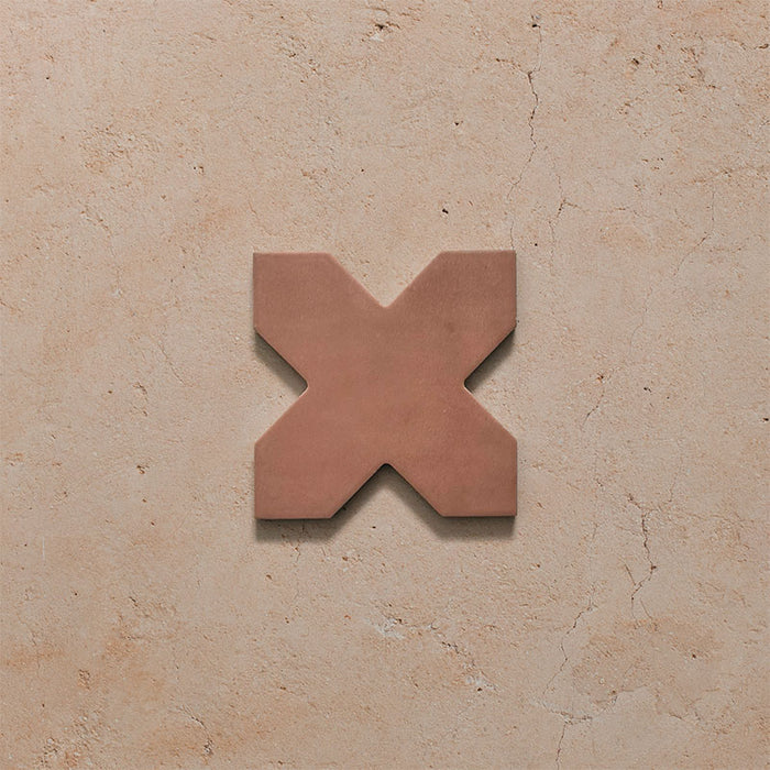 Close-up of a single Dohar Cotto Cross Moroccan style porcelain wall and floor tile, showcasing the distinctive cross shape, warm terracotta tone and soft matt finish.