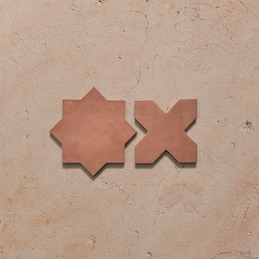 Close-up of Dohar Cotto Star and Cross Moroccan style porcelain wall and floor tiles, showcasing complementary geometric shapes, warm terracotta tones and a soft matt finish.