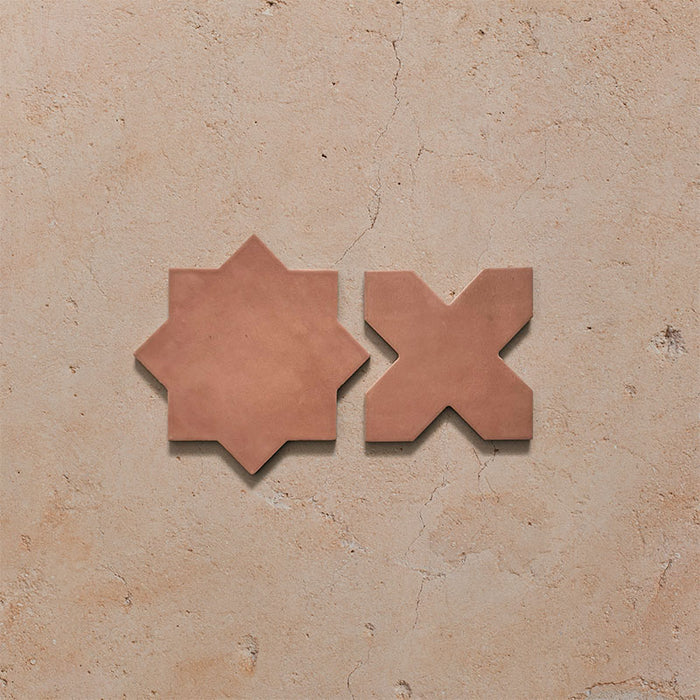 Close-up of Dohar Cotto Star and Cross Moroccan style porcelain wall and floor tiles, showcasing complementary geometric shapes, warm terracotta tones and a soft matt finish.