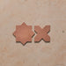 Close-up of Dohar Cotto Star and Cross Moroccan style porcelain wall and floor tiles, showcasing complementary geometric shapes, warm terracotta tones and a soft matt finish.