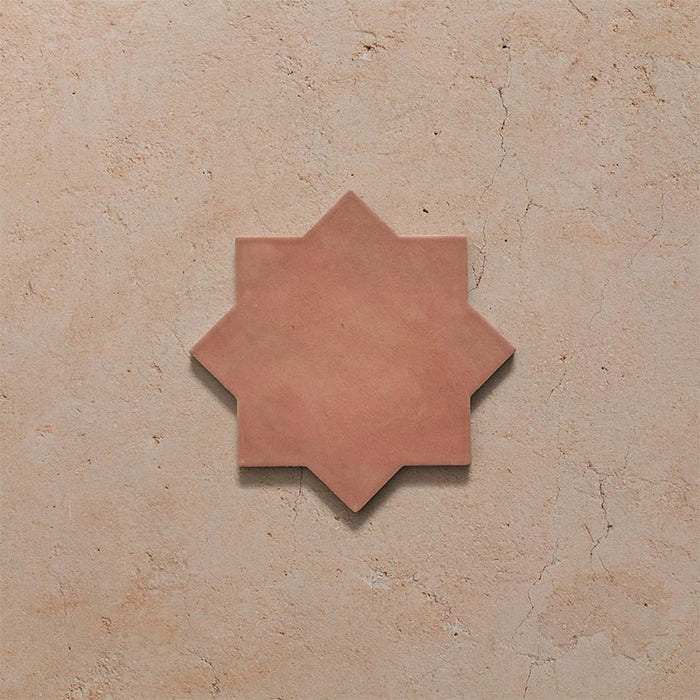 Close-up of a single Dohar Cotto Star Moroccan style porcelain wall and floor tile, showcasing the distinctive eight-point star shape, warm terracotta tone and soft matt finish.