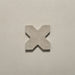 Close-up of a single Dohar Sands Cross porcelain wall and floor tile, showcasing the distinctive cross shape, warm sandy beige tone, speckled surface detail and subtle matt finish.