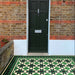 Maison Green Decor Victorian Pattern 20cm x 20cm walkway setting, Victorian-style patterned floor tiles laid in a geometric diamond design, rich green, black and white colour palette, matt finish with decorative border detailing, classic heritage-inspired design used in an outdoor entrance walkway.