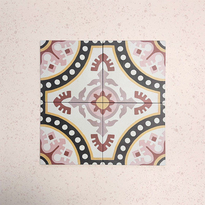 Four Europa Dortmund 20x20cm Victorian Moroccan style tiles arranged together to showcase the repeating decorative pattern in red, cream, black and mustard tones, displayed against a textured blush background.