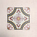 Four Europa Dortmund 20x20cm Victorian Moroccan style tiles arranged together to showcase the repeating decorative pattern in red, cream, black and mustard tones, displayed against a textured blush background.