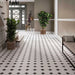 Hallway featuring Durham Black 33 × 33cm Victorian style porcelain floor tiles, creating a classic geometric pattern with black and white contrast. Paired with neutral walls and traditional details for a timeless, elegant finish.