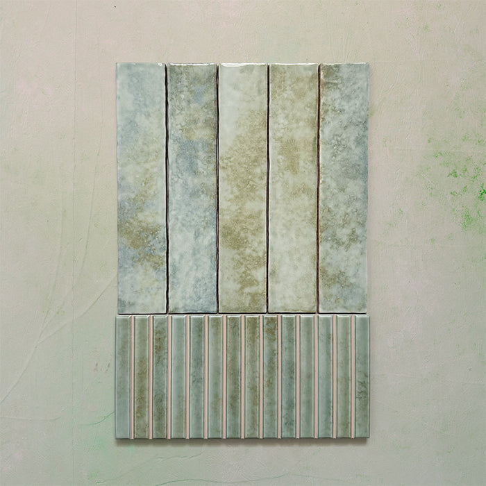Product display of Elazar Decor Agave Green 12.5x25cm ceramic wall tiles in soft green tones, featuring a handcrafted glossy finish with coordinating fluted decorative tiles for textured contemporary interiors.
