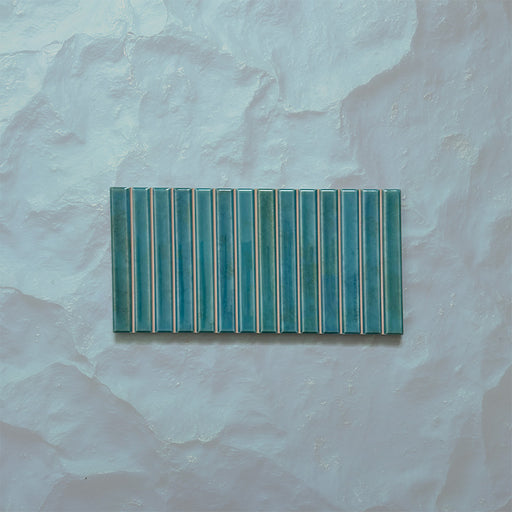 Product display of Elazar Decor Azul Blue 12.5x25cm ceramic wall tiles in vibrant blue tones, featuring a linear fluted design, handcrafted glossy finish and subtle tonal variation for textured contemporary interiors.