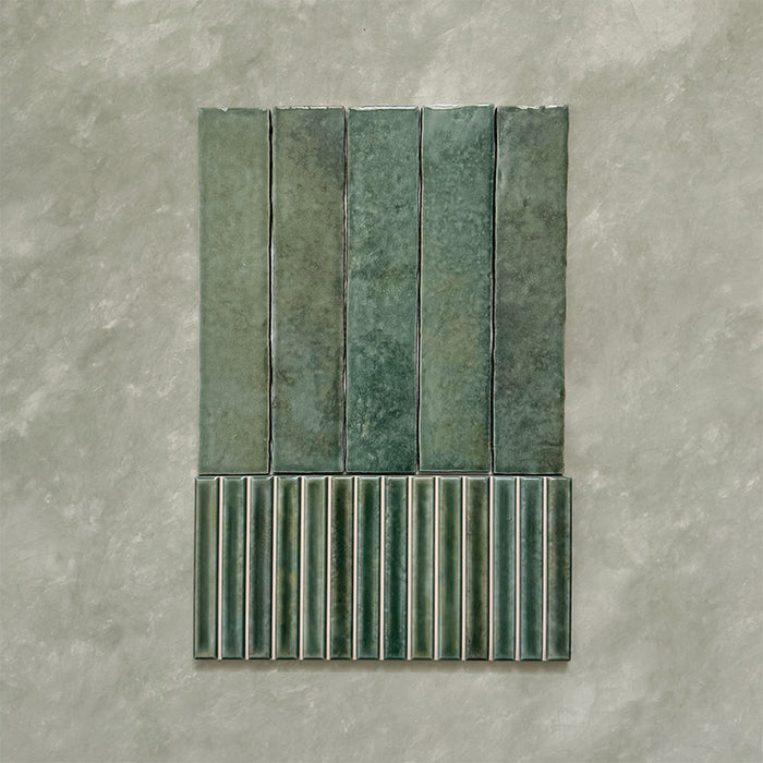 Product display of Elazar Decor Forest Green 12.5x25cm ceramic wall tiles in deep green tones, featuring a handcrafted glossy finish with coordinating fluted decorative tiles for textured contemporary interiors.