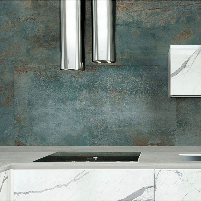 Contemporary kitchen featuring Elements Oxide 30cm x 60cm metallic effect wall tiles, paired with marble-effect cabinetry, chrome extractor hood and sleek worktops for an industrial-inspired interior.