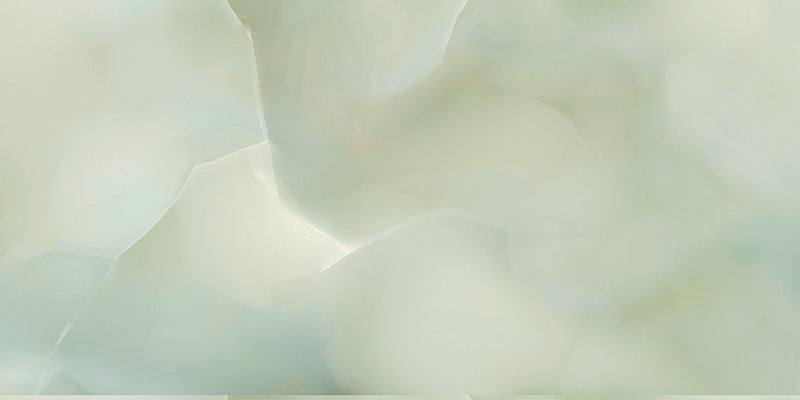Close-up of Fantasia Jade Green Onyx Matt 60 × 120cm stone effect tile, featuring soft green tones with flowing gold and amber veining, creating a layered, organic pattern with a smooth matt finish.