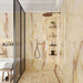 Walk-in shower featuring Fantasia Miele Onyx Matt 60 × 120cm stone effect wall tiles, styled with warm honey and amber veining across a soft cream base. The matt finish softens the natural onyx-inspired movement, paired with a coordinating mosaic shower floor, built-in niches, and brushed brass fittings for a calm, spa-like feel.