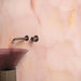 Bathroom detail featuring Fantasia Rose Onyx Matt 60 × 120cm stone effect wall tiles, showcasing soft blush pink tones with subtle gold veining, paired with a smoked glass basin and brushed metal wall-mounted tap for a warm, contemporary finish.