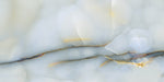 Close-up of Fantasia Turchese Blue Onyx Polished 60 × 120cm stone effect tile, featuring soft blue tones with flowing gold and grey veining, creating a layered, organic pattern with a high-gloss polished finish.