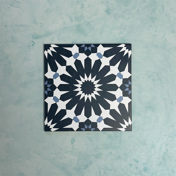 Single Fizaan Federal Blue 20x20cm Moroccan-style porcelain tile featuring a bold geometric pattern in deep blue and soft neutral tones.