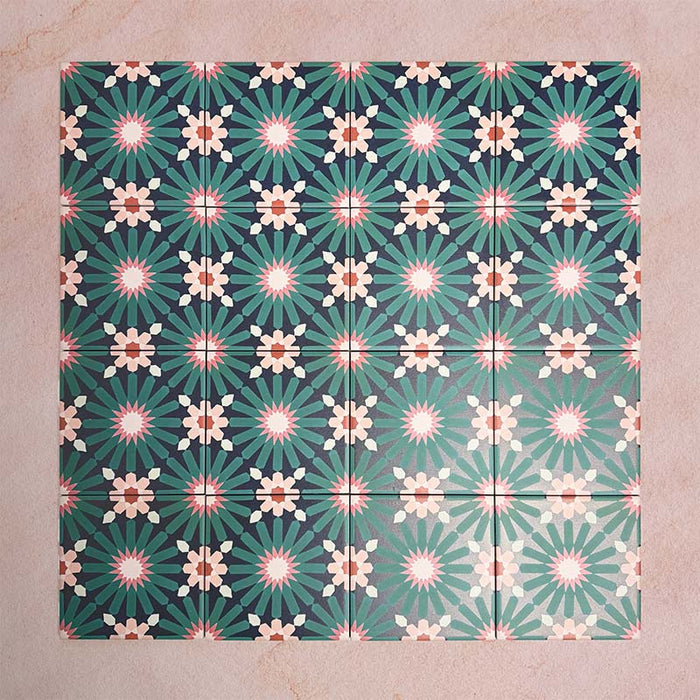 Arrangement of Fizaan Festive Blue Mini 15x15cm Moroccan-style porcelain tiles, showcasing a repeating geometric pattern in rich blue, green and soft neutral tones.