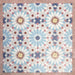 Arrangement of Fizaan Fiera 20x20cm Moroccan-style porcelain tiles, showcasing a repeating geometric pattern in soft blue, red and neutral tones.