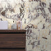 Contemporary bathroom featuring Fitzrovia Calacatta Viola honed natural marble mosaic wall tiles in a brick pattern, showcasing dramatic purple and warm gold veining. Styled with a dark wood vanity, countertop basin and minimalist accessories for a luxurious, timeless finish.