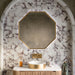 Bathroom featuring Fitzrovia Calacatta Viola Honed Finish natural marble 15.2cm x 15.2cm wall and floor tiles, paired with a fluted wood vanity, brushed brass basin, octagonal mirror and arched alcove for a luxurious bathroom design.