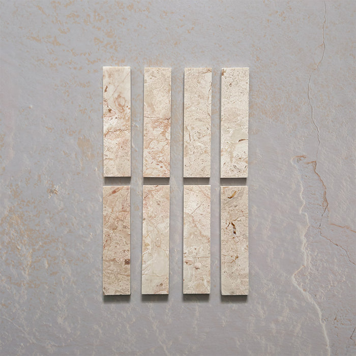 Fitzrovia Sylvester Pink 5cm x 20cm honed natural marble tiles, featuring soft pink, cream and beige tones with natural veining, creating an elegant and timeless wall tile design.