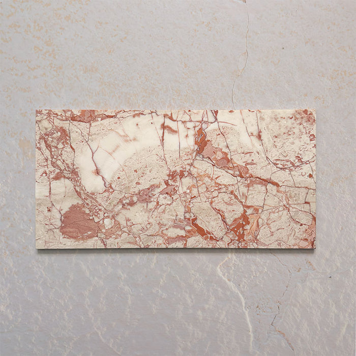 Sylvester Pink honed natural marble tiles in a 30.5cm x 61cm format, showcasing natural variation with soft blush pink, cream and warm terracotta veining for a luxurious, timeless natural stone finish.