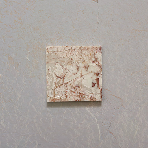 Close-up of Fitzrovia Sylvester Pink honed natural marble tile in a 15.2cm x 15.2cm square format, featuring soft blush pink, cream and warm terracotta veining with natural variation for a luxurious, timeless natural stone finish.