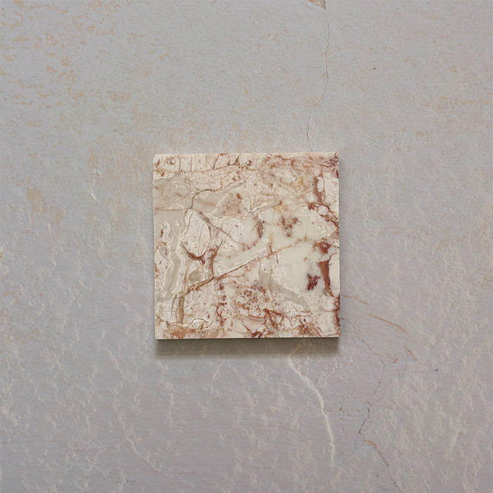 Close-up of Fitzrovia Sylvester Pink honed natural marble tile in a 15.2cm x 15.2cm square format, featuring soft blush pink, cream and warm terracotta veining with natural variation for a luxurious, timeless natural stone finish.