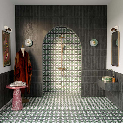 Bathroom featuring Fitzrovia Verde Honed Finish Natural Marble 5cm x 20cm wall tiles, paired with Geometry Hourglass patterned floor tiles, an arched walk-in shower, brushed brass fittings, a floating vanity and elegant green marble detailing.