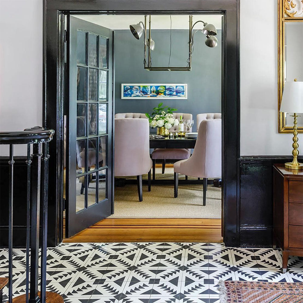 Alhambra Alkazar 20x20cm Moroccan floor tiles featured in a stylish hallway leading to a dining room, showcasing a bold black and white geometric pattern that adds striking contrast and contemporary elegance.