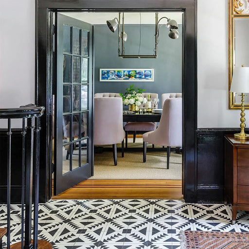 Alhambra Alkazar 20x20cm Moroccan floor tiles featured in a stylish hallway leading to a dining room, showcasing a bold black and white geometric pattern that adds striking contrast and contemporary elegance.