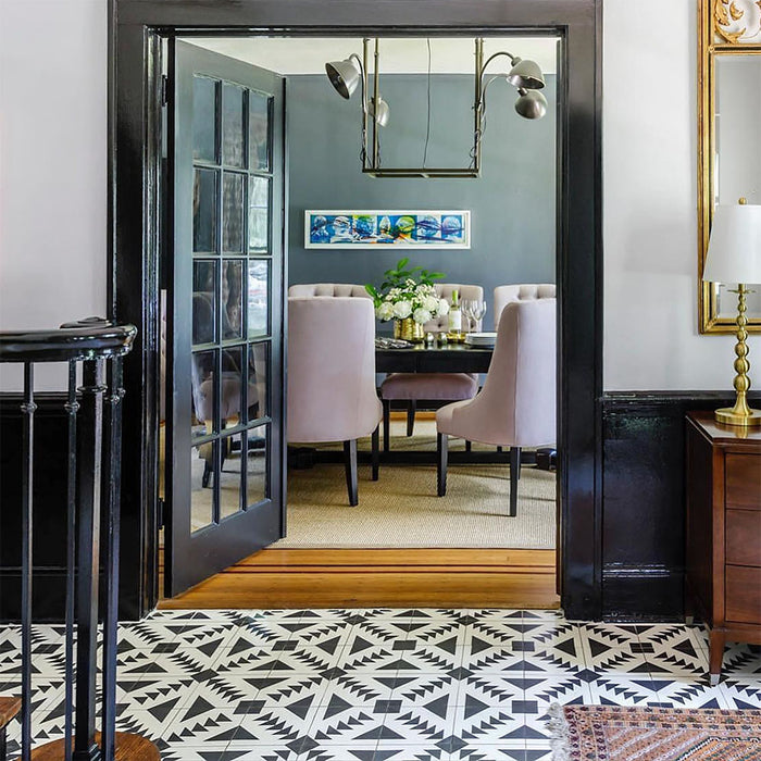 Alhambra Alkazar 20x20cm Moroccan floor tiles featured in a stylish hallway leading to a dining room, showcasing a bold black and white geometric pattern that adds striking contrast and contemporary elegance.