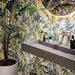 Bathroom featuring Forest Decor Light 60x120cm botanical-style wall tiles, showcasing a tropical leaf design in soft green, blue and beige tones, paired with a floating grey vanity, contemporary basin and lush indoor planting.