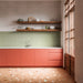 Kitchen featuring Fragmenta Terracotta 60cm x 120cm terrazzo effect porcelain floor tiles, showcasing warm terracotta tones and scattered stone-style fragments, paired with green textured wall tiles, coral cabinetry and warm wood details.