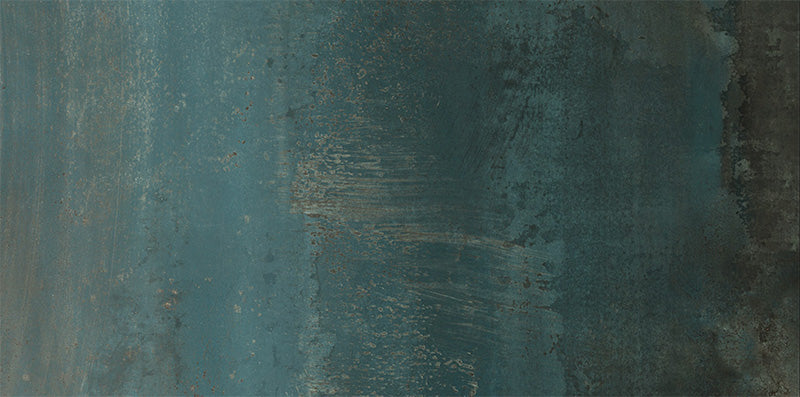 Close-up of Furnace Cuprum Oxide Metallic 60 × 120cm porcelain tile, showcasing deep blue-green tones layered with warm copper oxidation, soft tonal variation, and a gently textured metallic effect for a bold, industrial-inspired finish.