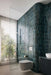 Modern bathroom featuring Fusion Marine Blue 6.5x20cm gloss brick wall tiles, showcasing rich blue-green shade variation wrapped around curved walls, paired with a frameless walk-in shower, dark fluted vanity, white basin and large window for a contemporary spa-inspired finish.