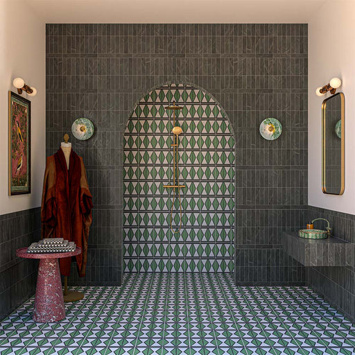 Bathroom featuring Geometry Hourglass 20cm x 20cm patterned floor tiles, paired with dark fluted wall tiles, an arched walk-in shower, brushed brass fittings, floating vanity and bold geometric green feature tiles.
