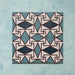Group image showing four Geometry Iris 20x20cm patterned tiles arranged to form a continuous geometric motif in teal, navy, terracotta-red, and cream, photographed against a soft mottled aqua background.
