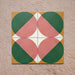 Group image showing four Geometry Paloma 20x20cm geometric patterned tiles arranged to form a circular motif, featuring pink and green semicircles with mustard and cream corner accents, photographed against a textured stone background.