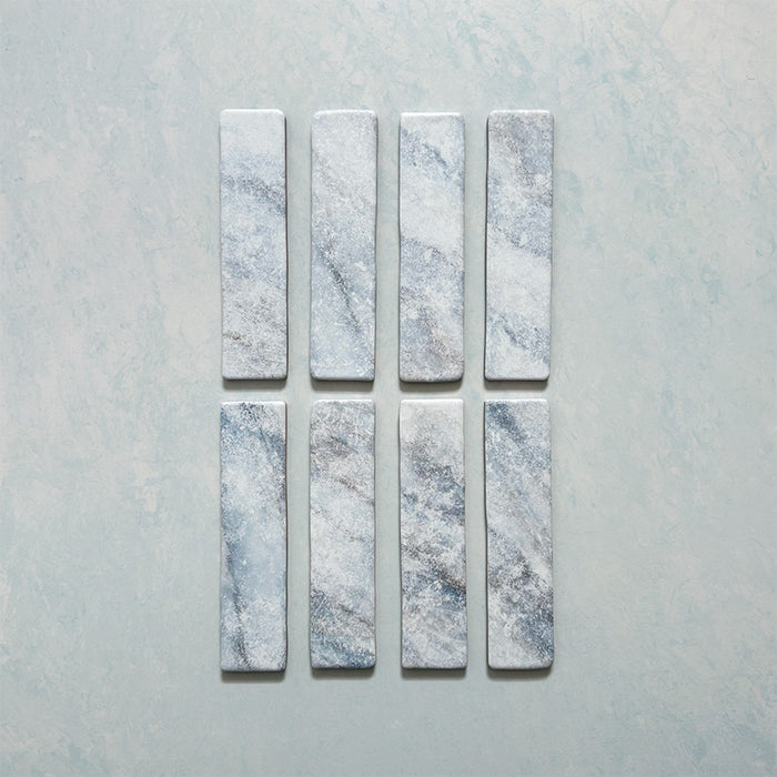 Product image of Giovanni Brick Azul Vintage Marble wall and floor tiles in a 5.4cm x 22cm format, featuring soft blue and white marble effect detailing, subtle veining and rounded vintage-inspired edges.