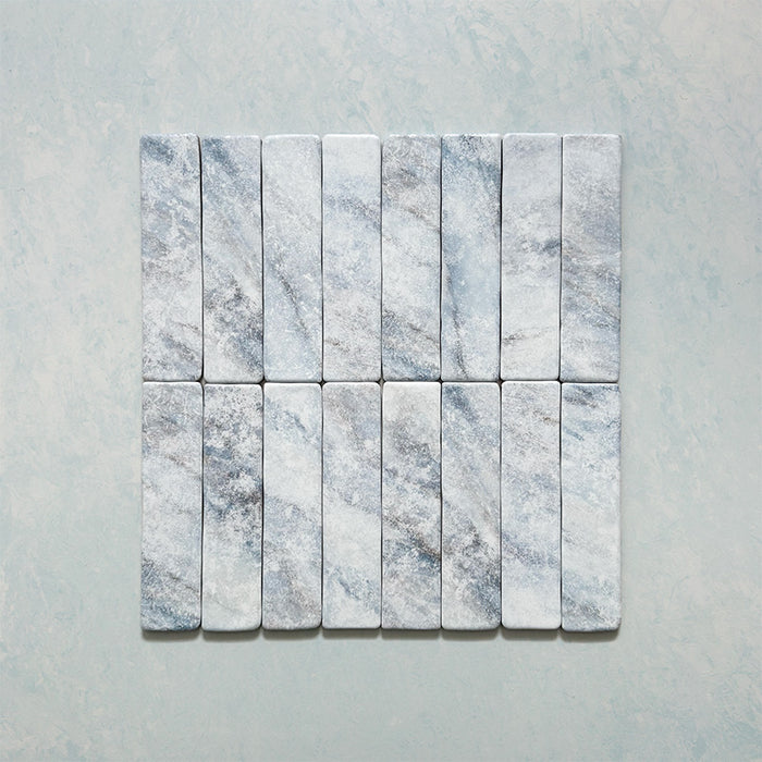 Product image of Giovanni Brick Azul Vintage Marble wall and floor tiles in a 5.4cm x 22cm format, featuring soft blue and white marble effect detailing, subtle veining and rounded vintage-inspired edges.