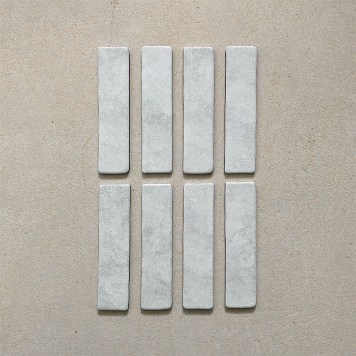 Product image of Giovanni Brick Carrara Vintage Marble wall and floor tiles in a 5.4cm x 22cm format, featuring a soft white marble effect surface with subtle tonal variation and rounded vintage-inspired edges.