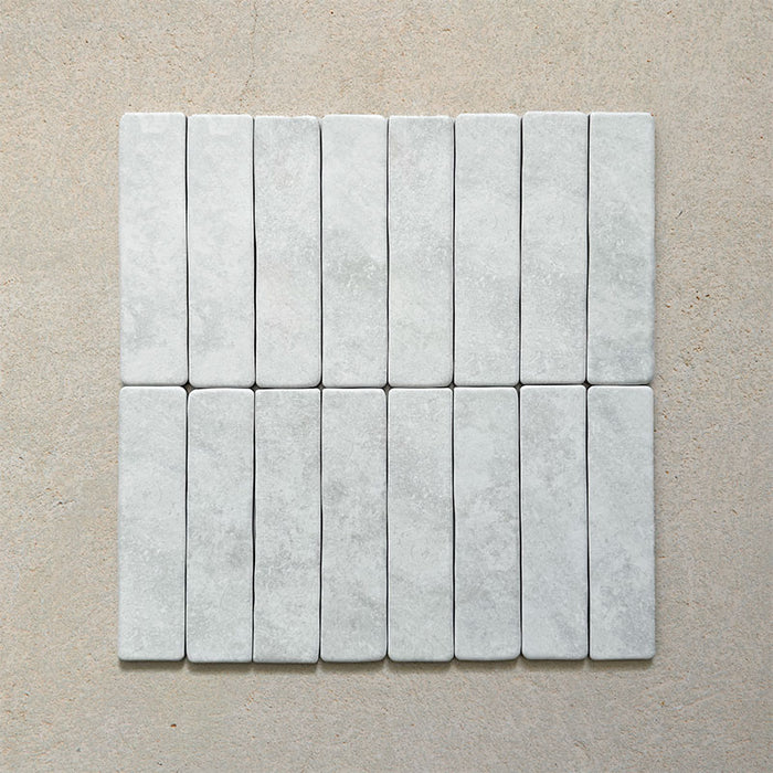 Product image of Giovanni Brick Carrara Vintage Marble wall and floor tiles in a 5.4cm x 22cm format, featuring a soft white marble effect surface with subtle tonal variation and rounded vintage-inspired edges.