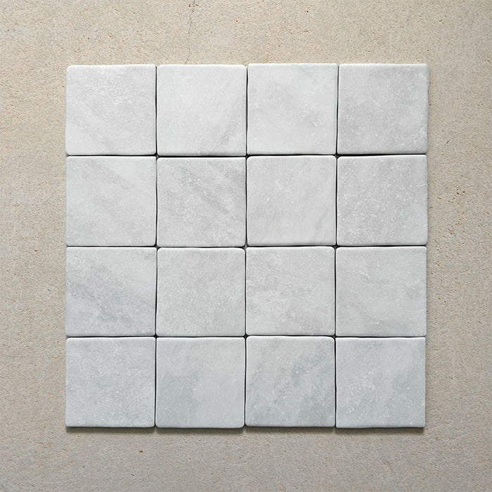 Product image of Giovanni Square Carrara Vintage Marble wall and floor tiles in an 11cm x 11cm format, featuring a soft white marble effect surface with subtle tonal variation and rounded vintage-inspired edges.