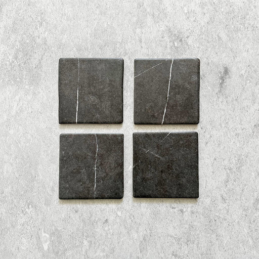 Product image of Giovanni Square Nero Vintage Marble wall and floor tiles in an 11cm x 11cm format, featuring a dark charcoal marble effect surface with subtle white veining and rounded vintage-inspired edges.